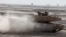 FILE - Iraqi army soldiers in a M1A1 Abrams tank, purchased from the U.S., participate in joint training with U.S. troops at the Besmaya Combat Training Center southeast of Baghdad, Iraq, Aug 24, 2010.