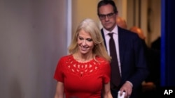 Counselor to President Donald Trump Kellyanne Conway, is followed by National Security spokesman Michael Anton during the daily press briefing in the Brady press briefing room at the White House, in Washington, Jan. 23, 2018.