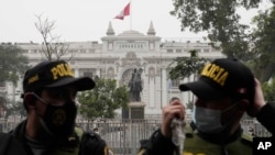 Police stand guard outside Congress where lawmakers are deciding their vote of confidence in Lima, Peru, Friday, Aug. 27, 2021. The vote of confidence is a legal mechanism to approve the cabinet of Peruvian President Pedro Castillo, a few weeks…