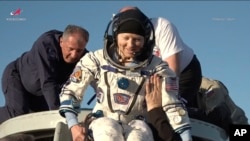 NASA astronaut Tracy Dyson is helped out of a Russian Soyuz MS-25 space capsule, which also carried Roscosmos cosmonauts Oleg Kononenko and Nikolai Chub, after its landing near Zhezkazgan, Kazakhstan, Sept. 23, 2024. (Roscosmos space corporation via AP)