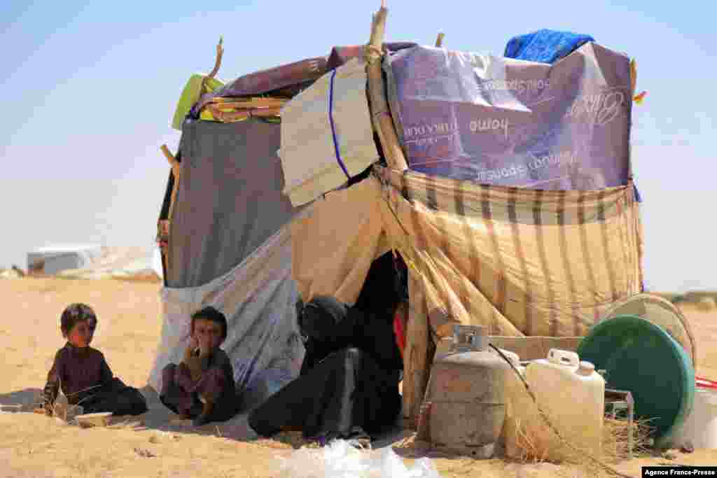 A woman sits with children at a camp for internally displaced people on the outskirts of Yemen&#39;s northeastern city of Marib, the final northern stronghold of pro-government forces, Nov. 3, 2021.