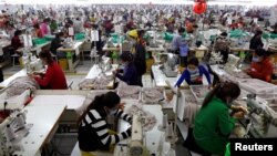 Employees work at a factory supplier of the H&M brand in Kandal province, Cambodia, Dec. 12, 2018.