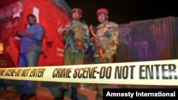 Security forces secure the scene around a vehicle explosion outside a police station in central Nairobi, April 23, 2014. 