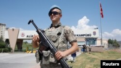 A Turkish soldier stands guard in front of the Aliaga Prison and Courthouse complex in Izmir, Turkey July 18, 2018. 