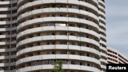 Solar panels face the sun from balconies of an apartment building in Mangyongdae district, Pyongyang, North Korea, Aug. 27, 2014.