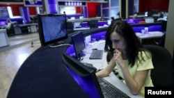 FILE - A journalist works at her desk in a newsroom of the Rustavi 2 TV station in Tbilisi, Georgia, Oct, 2, 2015.