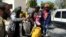 Members of Libyan internationally-recognized government forces evacuate an African family during the fighting with Eastern forces, at Al-Swani area in Tripoli, Libya, April 18, 2019. 