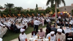 Le président Omar Hassan el-Béchir du Soudan et les membres de la communauté soudanaise orthodoxe prennent art à un repas de rupture du jeûne, Iftar, à la fin du Ramadan annuel à Khartoum, au Soudan, 23 août 2010. EPA / PHILIP DHIL