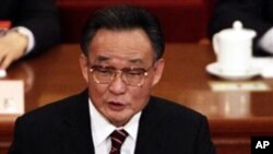 National People's Congress Chairman Wu Bangguo delivers a work report during a plenary session of the National People's Congress in Beijing, China.