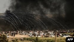 Israeli forces fire tear gas at demonstrators east of Gaza City along the border between the Gaza Strip and Israel during confrontations with Palestinian protesters, June 29, 2018. 