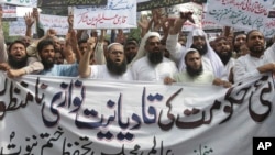 In this Sept. 7, 2018 file photo, Pakistani Islamists protest the appointment of a minority Ahmadi Muslim as an adviser to the government, in Lahore, Pakistan.