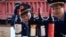 Police officers check bottles of confiscated fake wines before destroying them in Xi'an, Shaanxi province Jan. 4, 2012.
