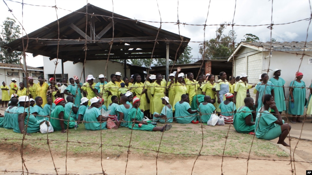 FILE - Female prisoners wait for their turn to walk out of prison following their release at Chikurubi Maximum prison on the outskirts of Harare, Feb. 17, 2014.