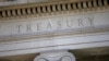 FILE - Part of the facade of U.S. Treasury Department building is shown at dusk in Washington, June 6, 2019.