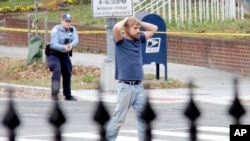 FILE - Edgar Maddison Welch, of Salisbury, N.C., surrenders to police in Washington on December 4, 2016. Comet Ping Pong was targeted in the “Pizzagate” conspiracy, which originated on Twitter and led an armed Welch to burst into the restaurant in 2016 to investigate the claims.