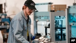 Graham Purrell prepares a master plate for creating vinyl records at the United Record Pressing plant July 11, 2024, in Nashville, Tenn.