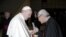 In this Jan. 10, 2018 photo made available the Vatican newspaper L'Osservatore Romano, retired archbishop of Hong Kong Cardinal Joseph Zen hands a letter to Pope Francis at the end of his weekly general audience.