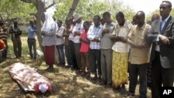 Mourners attend the funeral for Abdisatar Dahir Sabriye, a journalist with state-run television who fell victim to a recent suicide bombing, Mogadishu, Sept. 21, 2012.