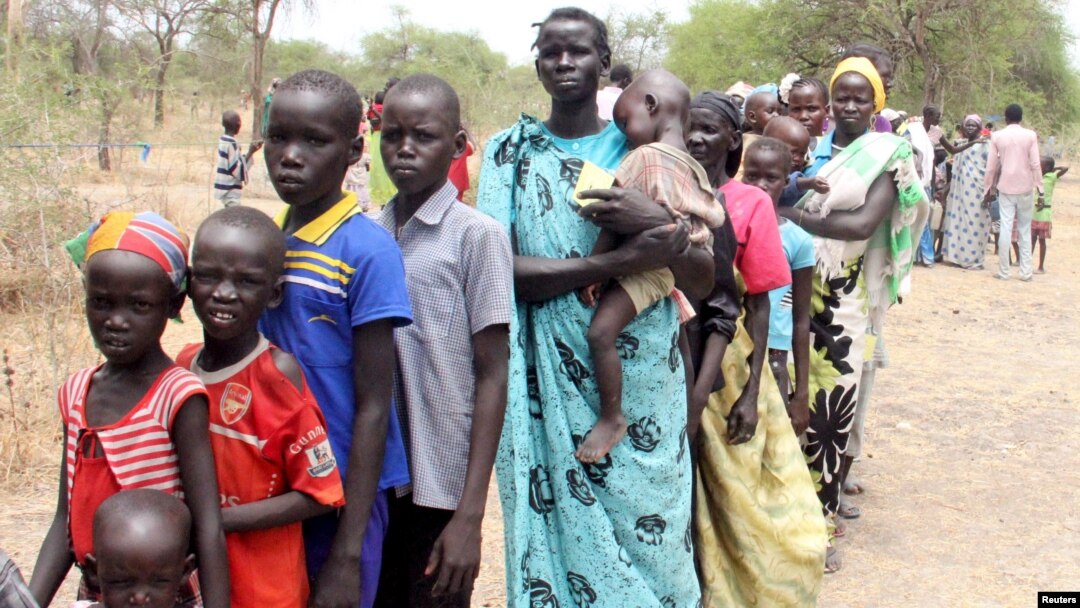 FILE - Residents displaced due to the recent fighting between government and rebel forces in the Upper Nile capital Malakal wait at a World Food Program (WFP) outpost.