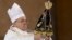 Pope Francis holds up the statue of the Virgin of Aparecida, Brazil's patron saint, during Mass in the Aparecida Basilica in Aparecida, Brazil, July 24, 2013. 