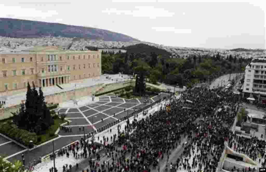 Protesters take part in a rally outside the Greek Parliament in central Athens, Wednesday, Dec. 15, 2010. Hundreds of protesters clashed with riot police across central Athens Wednesday, smashing cars and hurling gasoline bombs during a massive labor prot