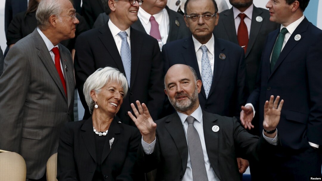 European Economic and Financial Affairs Commissioner Pierre Moscovici and International Monetary Fund Managing Director Christine Lagarde speak as they wait for a group photo of the G-20 finance ministers and central bank governors in Ankara, Turkey, Sept