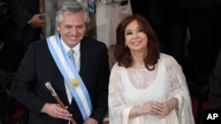 Argentina's new President Alberto Fernandez and Vice President Cristina Fernandez de Kirchner smile after they take the oath of office at the Congress in Buenos Aires, Argentina, Dec. 10, 2019. 