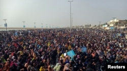 Supporters of the Balochistan Yakjehti Committee (BYC) listen to the speech of their leader during what they call the Baloch National Gathering in Gwadar, Pakistan July 28, 2024.