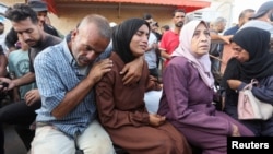 Mourners react near the bodies of Palestinians, who were killed in an Israeli strike, amid the Israel-Hamas conflict, at Al-Aqsa Martyrs Hospital in Deir Al-Balah in the central Gaza Strip, Oct. 9, 2024.