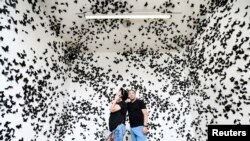 People look at artwork at the Stedelijk Museum, which reopened after the ease of coronavirus-related lockdown measures, in Amsterdam, Netherlands.