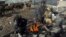 FILE - Afghan boys warm themselves near a bonfire on the cold day in a poor neighborhood on the outskirts of Kabul, Afghanistan, Dec. 17, 2017.