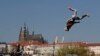 A member of the artistic group Cirk La Putyka performs on a trampoline to entertain residents as the movement remains restricted to stem the spread of the novel coronavirus in Prague, Czech Republic.