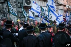 FILE—Members of the 'Brothers in Arms' reservist protest group demonstrate in the ultra-Orthodox neighborhood of Mea Shearim, demanding equality in Israel's military service, in Jerusalem on March 31, 2024