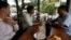 Men drink coffee and have breakfast at a coffee store in Phnom Penh, Cambodia July 19, 2018. (REUTERS/Samrang Pring)
