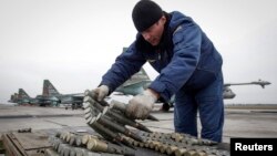 A serviceman checks ammunition next to Sukhoi Su-25 jet fighters during a drill at the Russian southern Stavropol region.