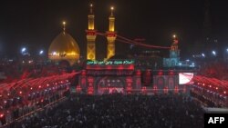 Shiite pilgrims take part in a ceremony at the Imam Hussein shrine in the southern Iraqi city of Karbala, Sept. 19, 2018, on the eve of the 10th day of the mourning period of Muharram, which marks the peak of Ashura. Ashura commemorates the death of Imam Hussein, grandson of the Muslim faith's prophet Mohammed, who was killed by the armies of his rival Yazid over the succession for the caliphate near Karbala in 680 AD. 