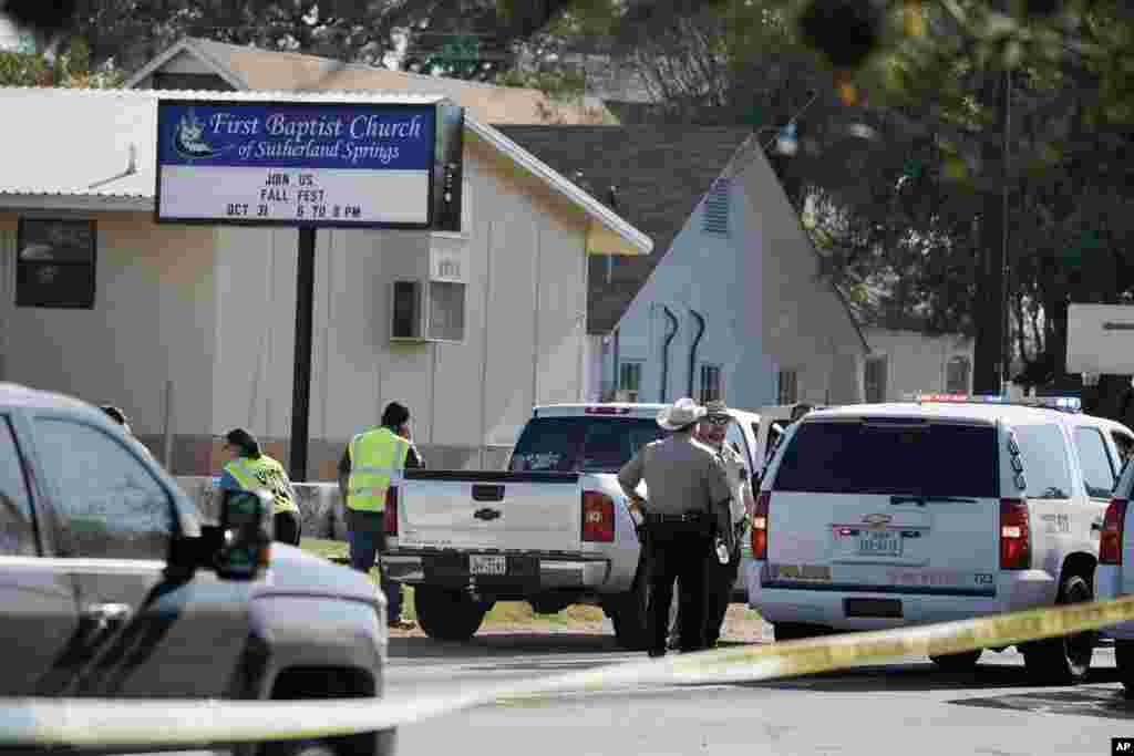 Law enforcement officers gather in front of the First Baptist Church of Sutherland Springs after a fatal shooting, Nov. 5, 2017, in Sutherland Springs, Texas.