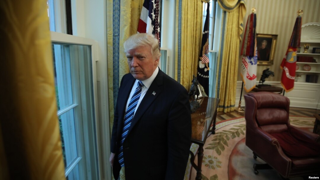U.S. President Donald Trump stands in the Oval Office following an interview with Reuters at the White House in Washington, April 27, 2017. 
