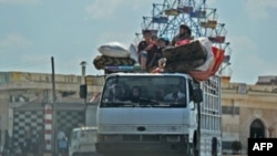 Syrian civilians flee a conflict zone in Syria's rebel-held northwestern region of Idlib, where government bombardment has killed hundreds since late April, near Maar Shurin on the outskirts of Maaret al-Numan, Aug. 22, 2019.