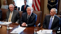 President Donald Trump speaks during a cabinet meeting at the White House as Secretary of State Rex Tillerson, left, and Secretary of Defense Jim Mattis, right, listen, Oct. 16, 2017.