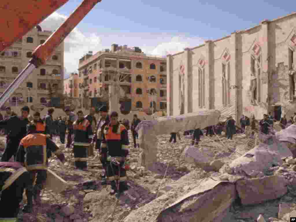 Syrian workers inspect the site of an explosion outside a military security building in Aleppo, February 10, 2012. (Reuters)