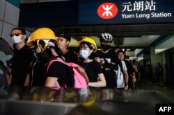 Protesters line up inside an MTR station in the Yuen Long district of Hong Kong, July 27, 2019, before an expected protest march in the afternoon.