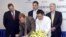 President and CEO of General Electric ASEAN, Stuart Dean, second from left, signs documents during the signing ceremony between Sea Lion Co. Ltd., General Electric Healthcare and Bahosi and Pun Hlaing Hospitals in Rangoon, Burma, July. 14, 2012. 