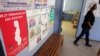 FILE - A pregnant woman walks through a community health care clinic in Askham village in the Kalahari, Northern Cape, South Africa, July 2, 2010. 