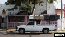 A pick-up truck transports unfinished coffins to another workshop in Jucuapa, El Salvador, April 7, 2016. 