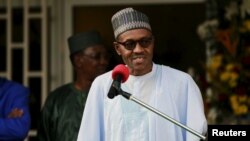 FILE - Nigeria's President Muhammadu Buhari speaks during a news conference after the Summit of Heads of State and Government of The Lake Chad Basin Commission (LCBC) in Abuja, Nigeria, June 11, 2015.