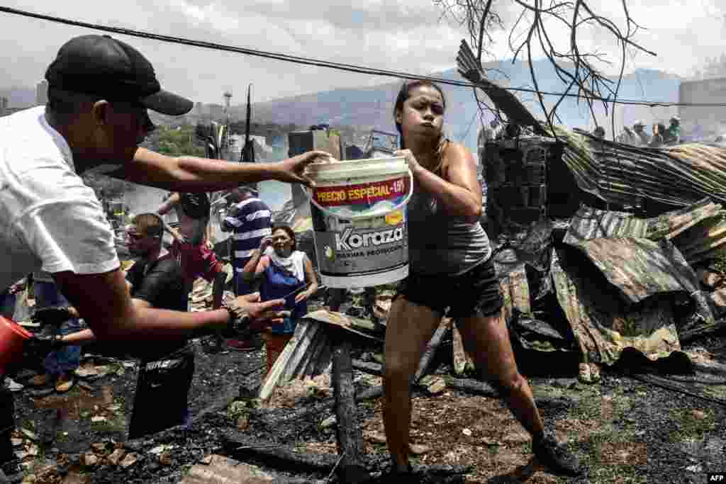 Local residents fight a wild fire in the Moravia neighborhood in Medellin, Colombia.