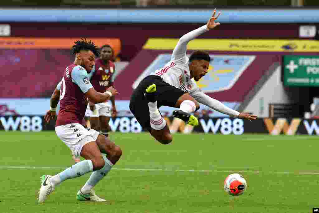 Sheffield United&#39;s Mbwana Samatta, right, is tackled by Aston Villa&#39;s Tyrone Mings during the English Premier League soccer match between Aston Villa and Sheffield United at Villa Park in Birmingham, England, June 17, 2020.
