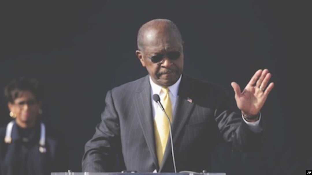 Republican presidential candidate Herman Cain announces he is suspending his campaign as his wife Gloria, left, looks on, Atlanta, Georgia, December, 3, 2011.