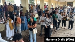 Voters line up at the Josina Machel secondary school during the general elections in Maputo, Mozambique, Oct. 9, 2024.